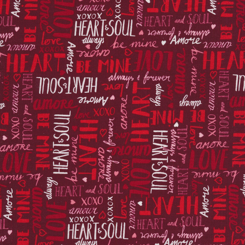 Fabric with red and white love-themed words all over a dark red background