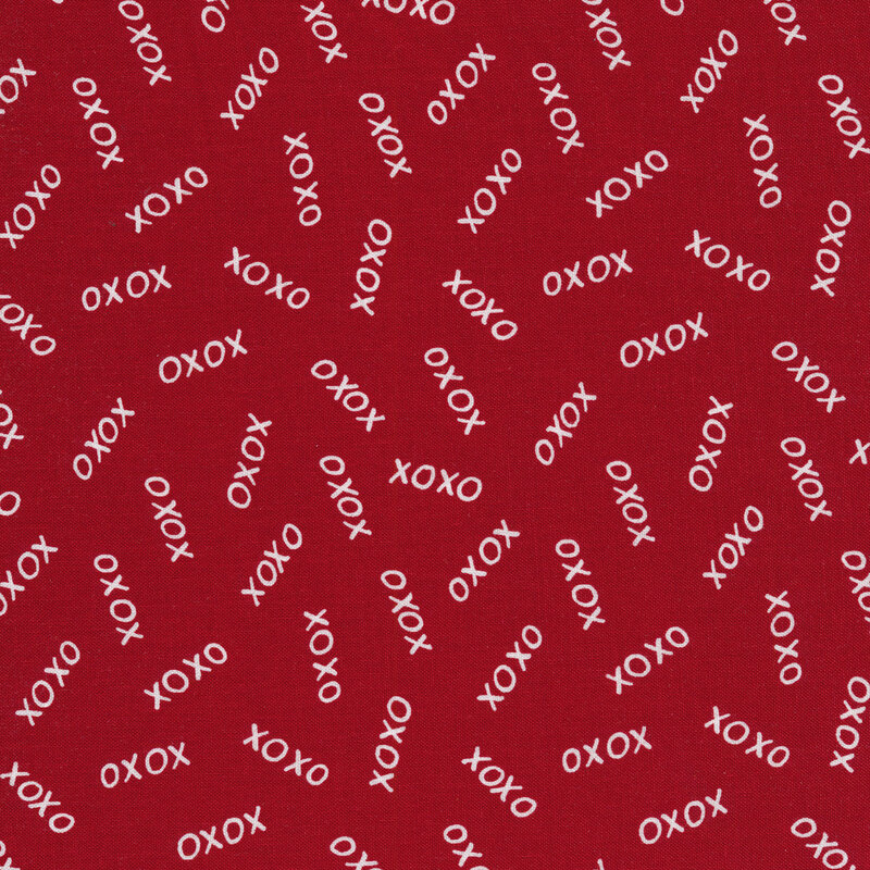 Red fabric with tossed white X's and O's all over