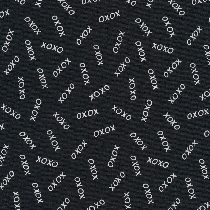 Fabric with white Xs and Os tossed on a black background