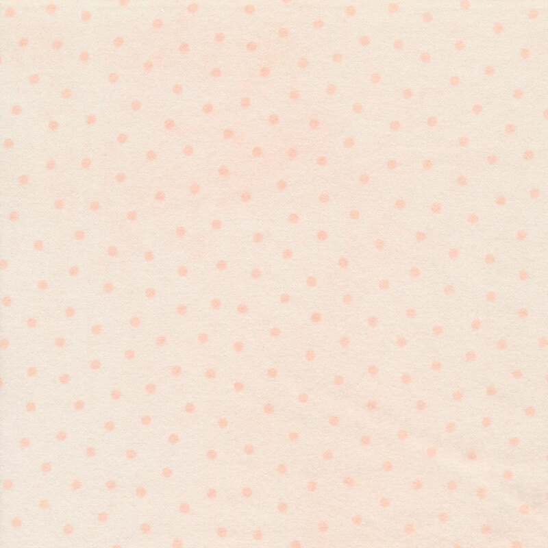 mottled light peach fabric with peach polka dots all over
