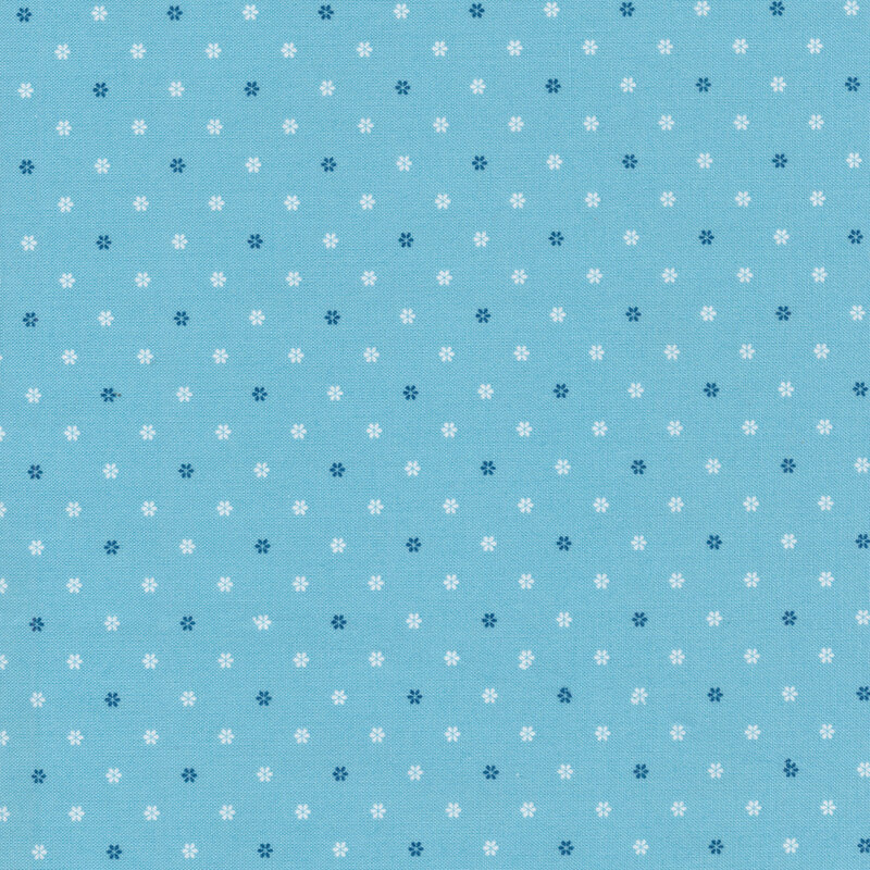 light blue fabric featuring white and blue flower shaped polka dots all over