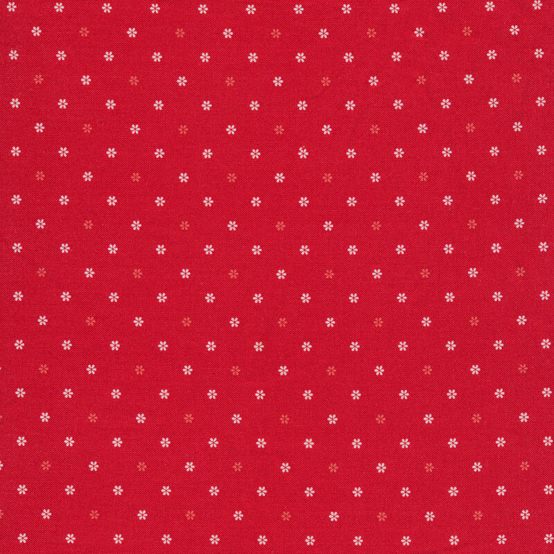 red fabric featuring white and red flower shaped polka dots all over