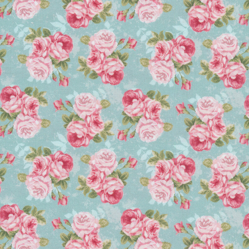 clusters of pink roses all over a blue fabric background