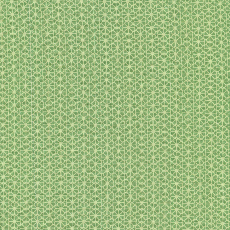 green fabric with geometric floral design all over 