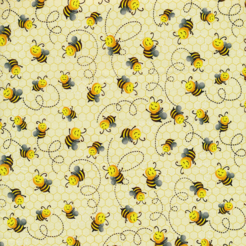 Pale yellow fabric covered with cartoon bees and spiraling lines behind them on a subtle, honeycomb background