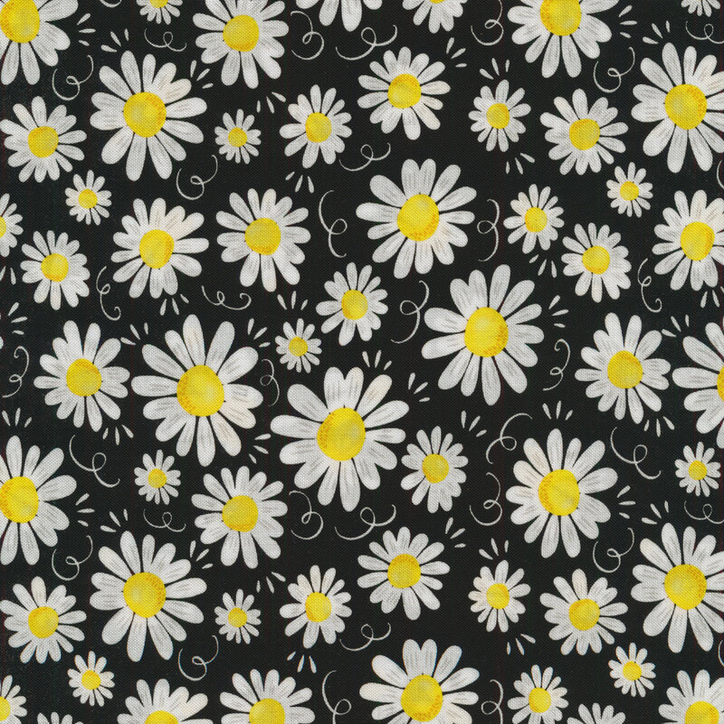 Black fabric covered with different sized white daisies with yellow centers