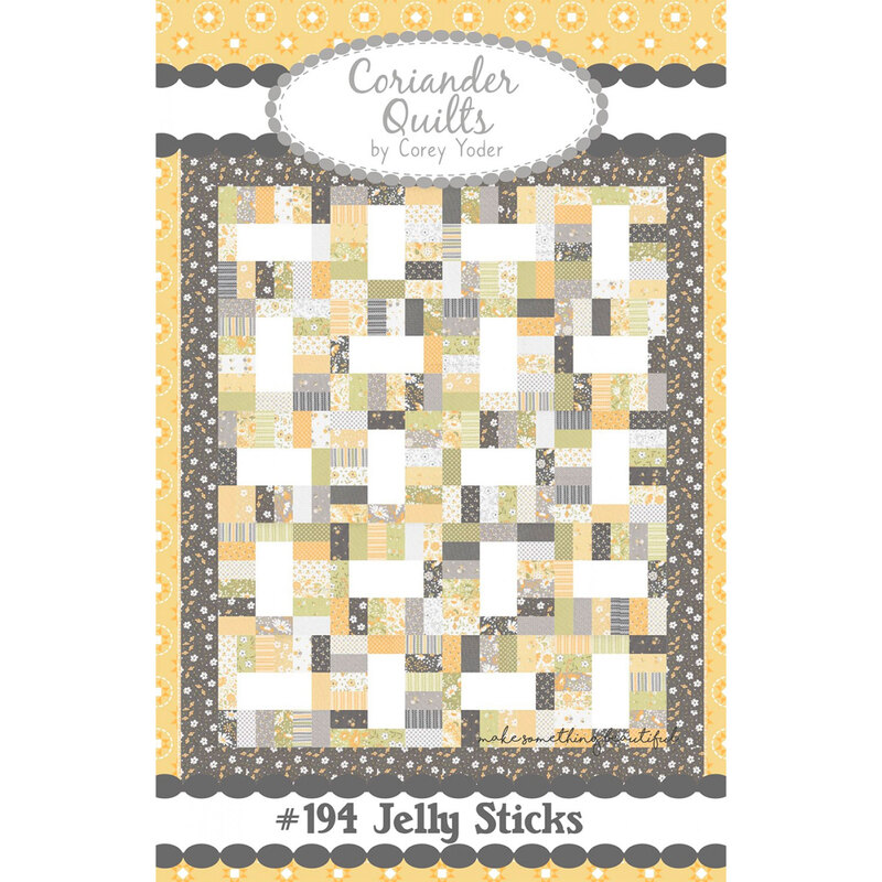 front image of pattern booklet showing a yellow and grey finished quilt