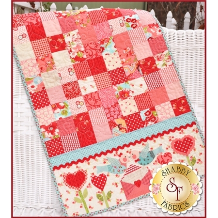 Pink patchwork table runner made from simple squares with kissing lovebirds applique.