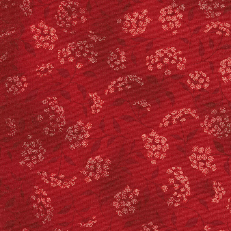 mottled red fabric featuring leaves, vines and florals 