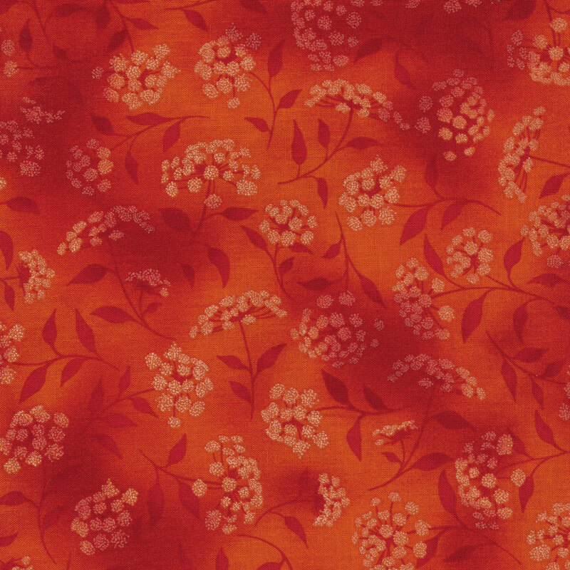 mottled dark orange fabric featuring leaves, vines and florals 