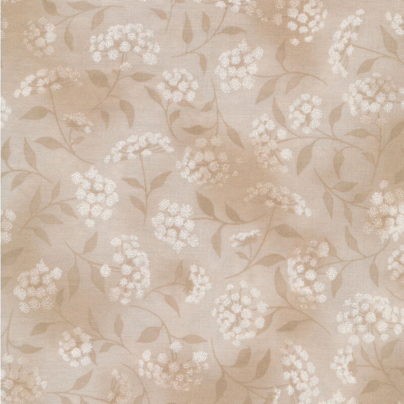 mottled tan fabric featuring leaves, vines and florals 