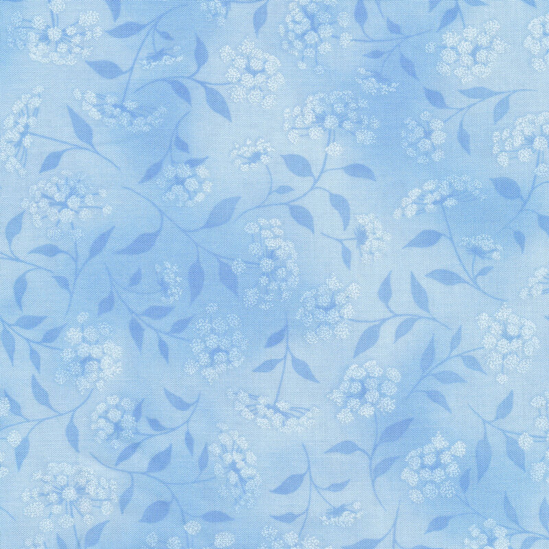 mottled light blue fabric featuring leaves, vines and florals 