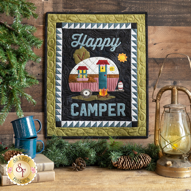 Wall hanging with appliqué camper and the phrase: 