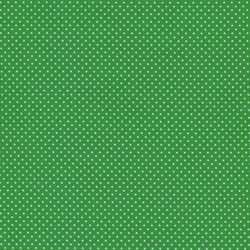 Green fabric with small white polka dots
