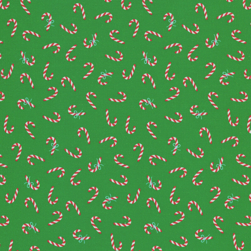 Green fabric with tossed candy canes all over