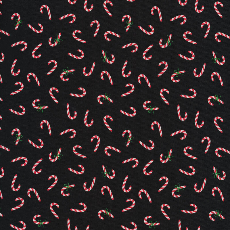 Black fabric with tossed candy canes all over