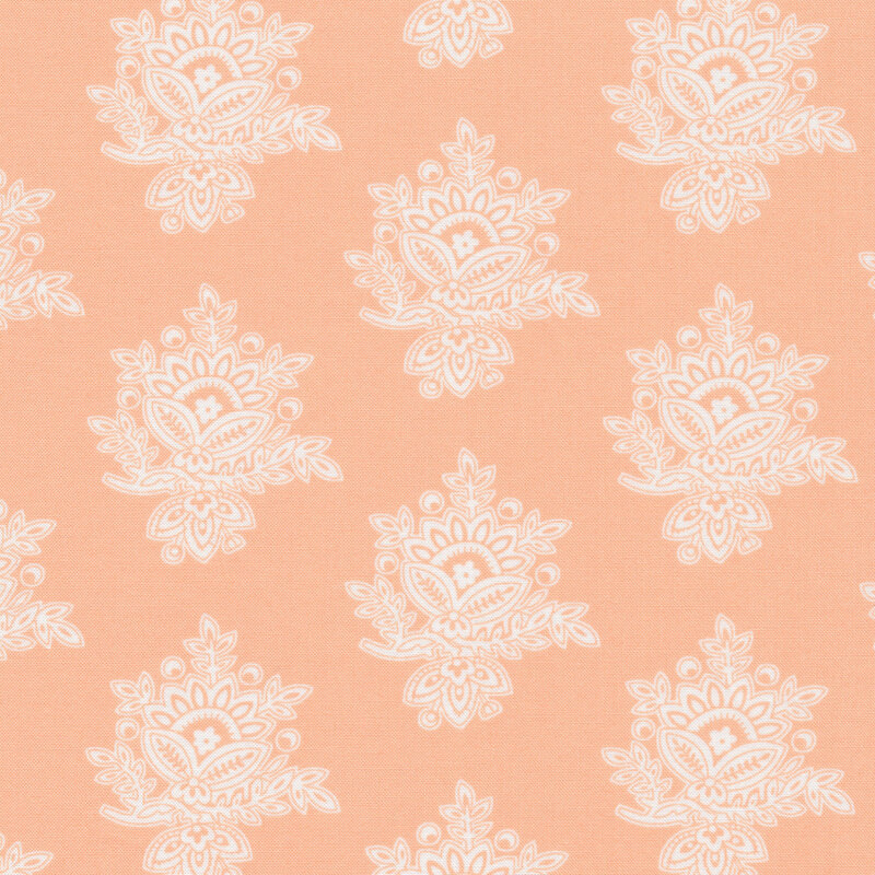 Peach fabric with large, cream colored intricate embellishments