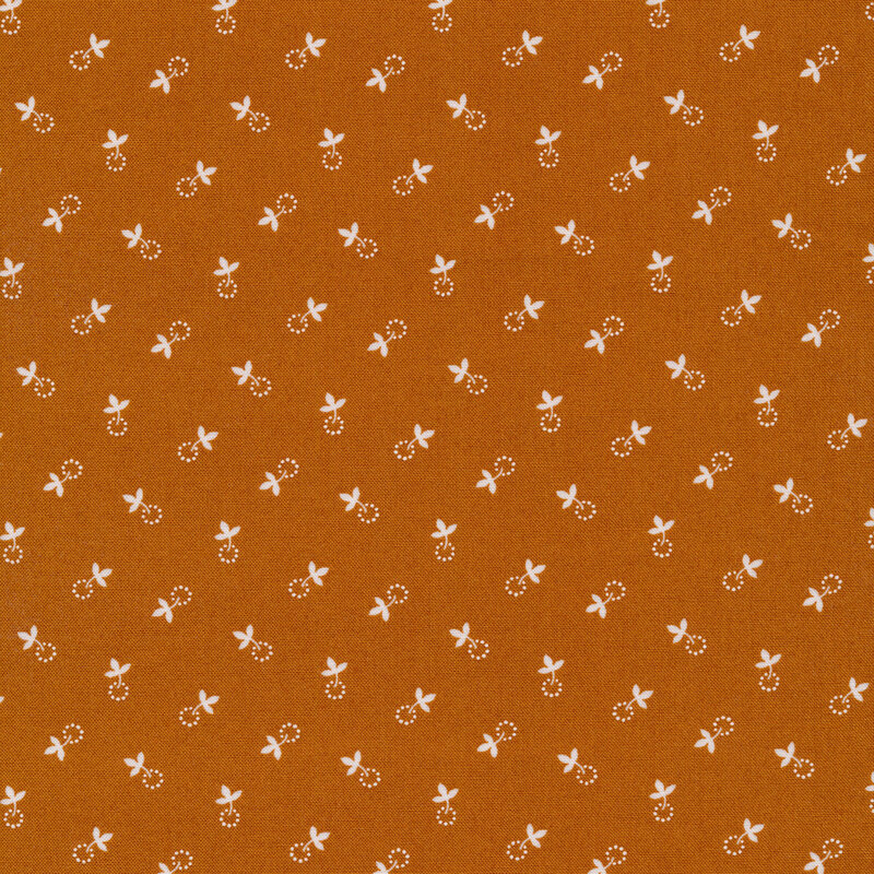 light brown fabric with small cream colored leaves