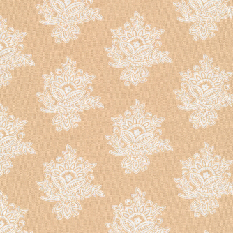 Tan colored fabric with large, cream colored intricate embellishments