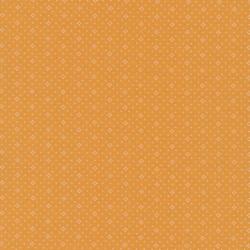 pale orange fabric with cream dots in a diamond pattern
