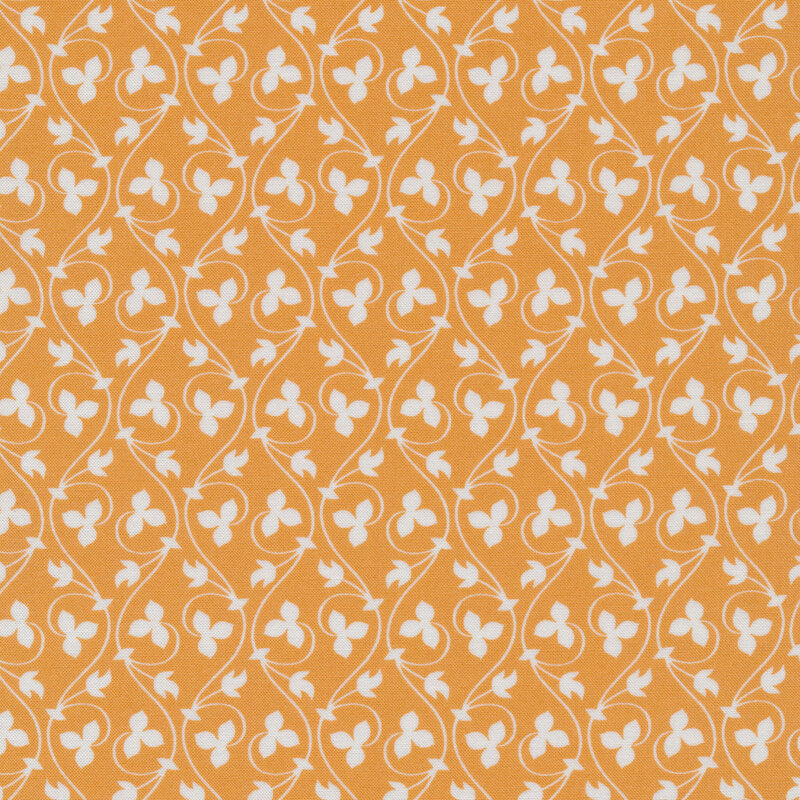 soft orange colored fabric with vertical, curving cream leaves and vines