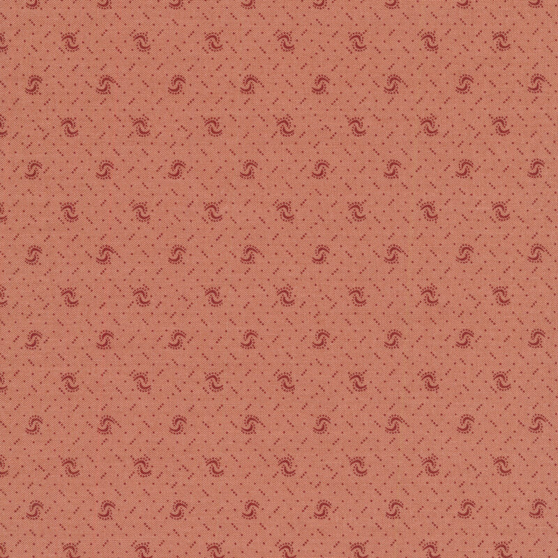Fabric of a pin dot and curved illustrative print on a dusty pink background.