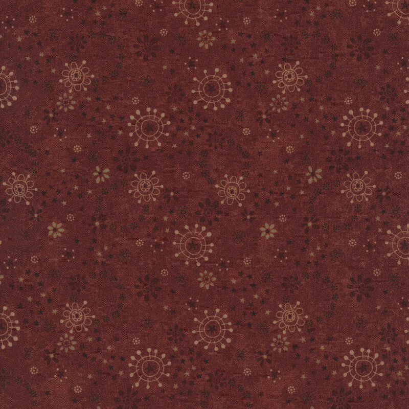 Red fabric with stylized flowers and burst patterns in cream and dark brown
