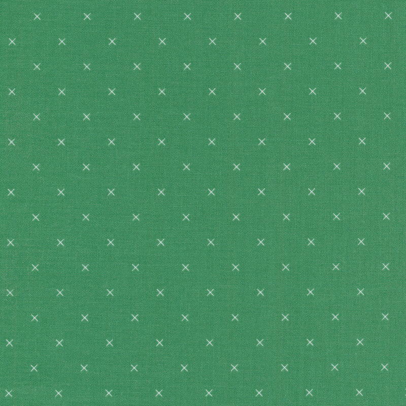Small cream x's on a green background