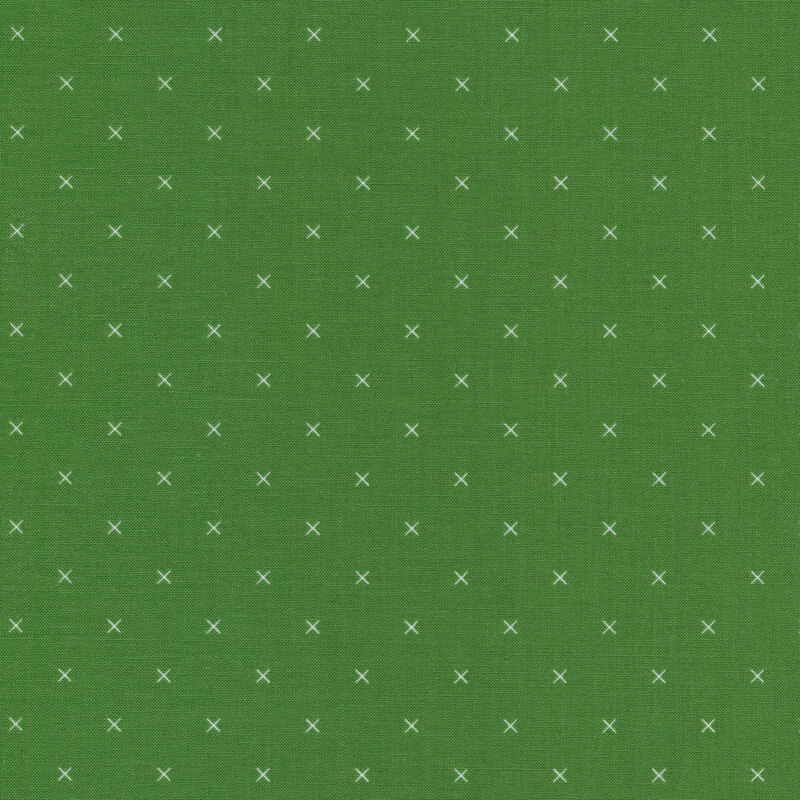 Small cream x's on a green background
