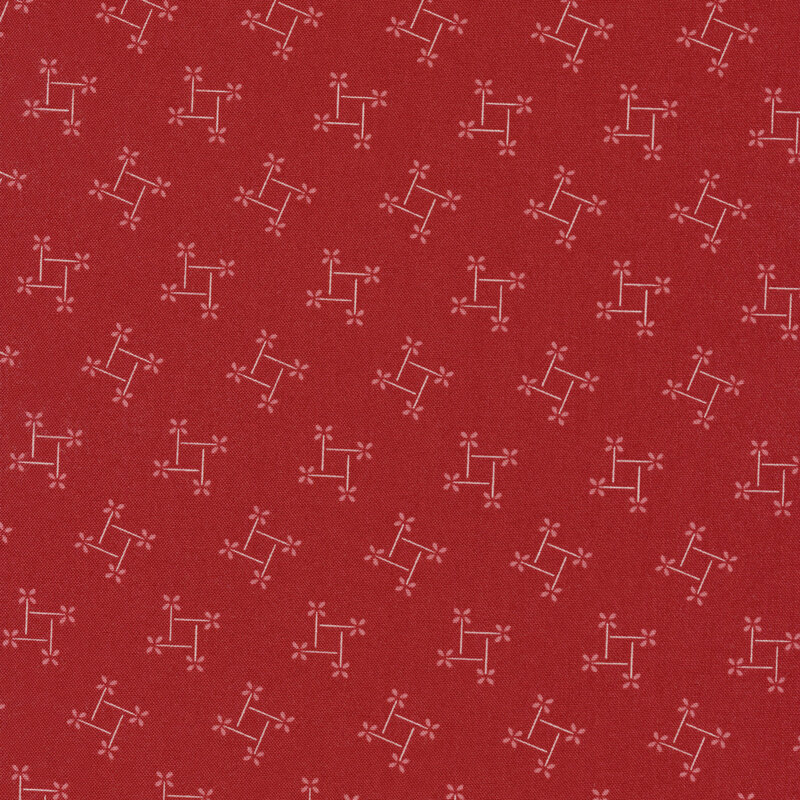 red fabric with white outline pinwheels with square space in the center