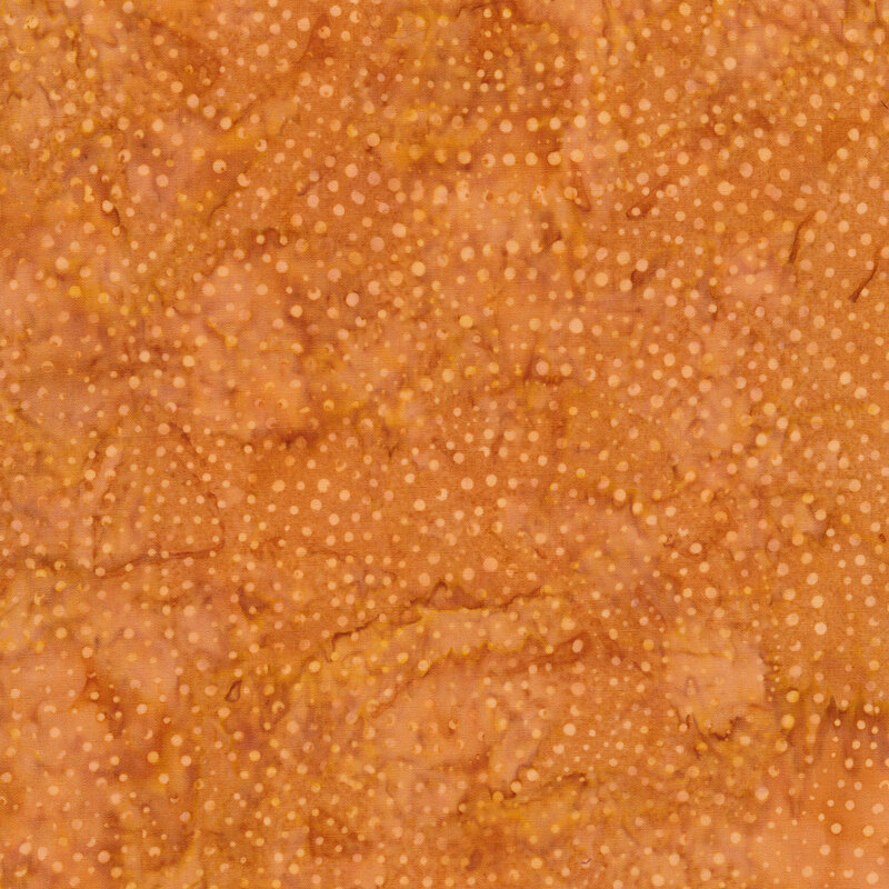 Brown mottled batik fabric with tonal light tan spiral dots