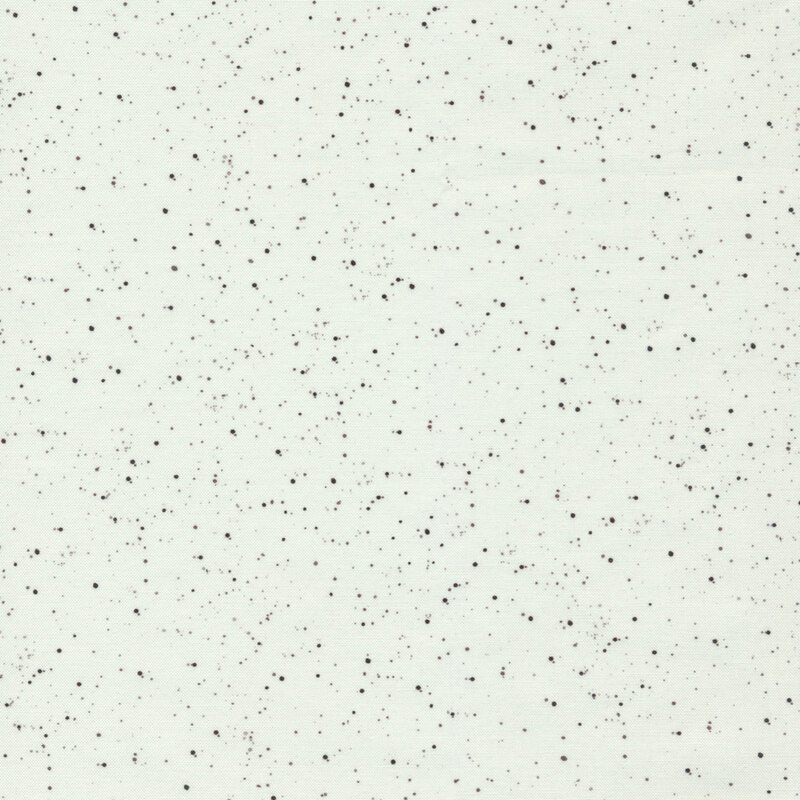 Small dark splatters on a solid white fabric
