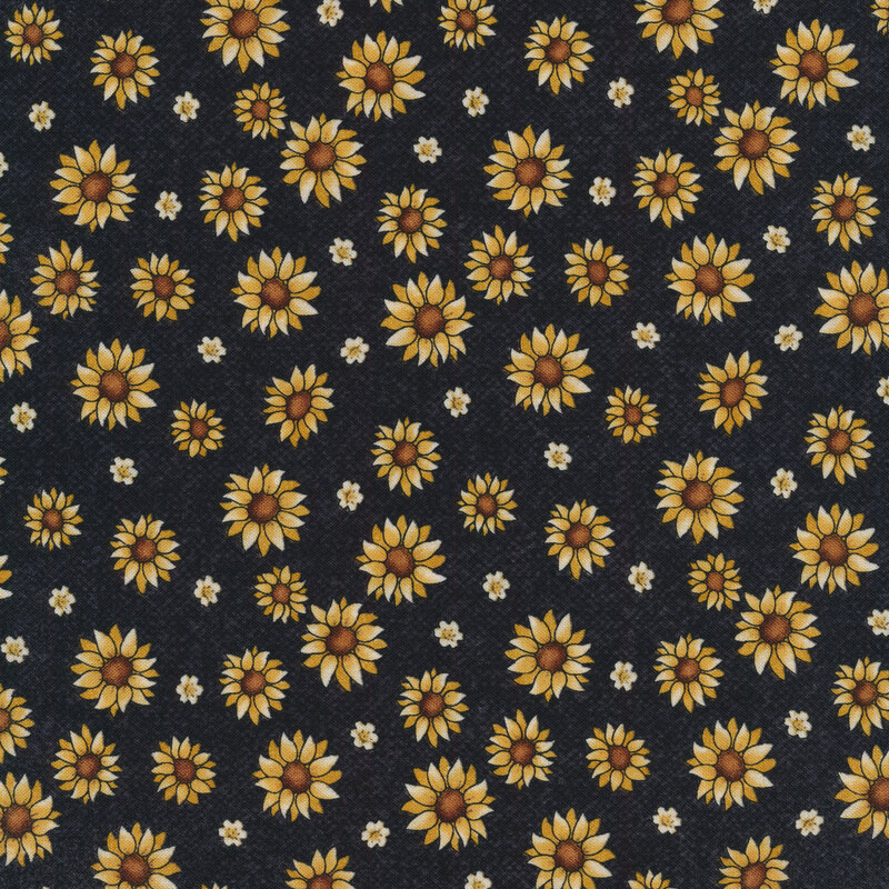 Sewing fabric with pumpkins, sunflowers, and leaves all over a black background