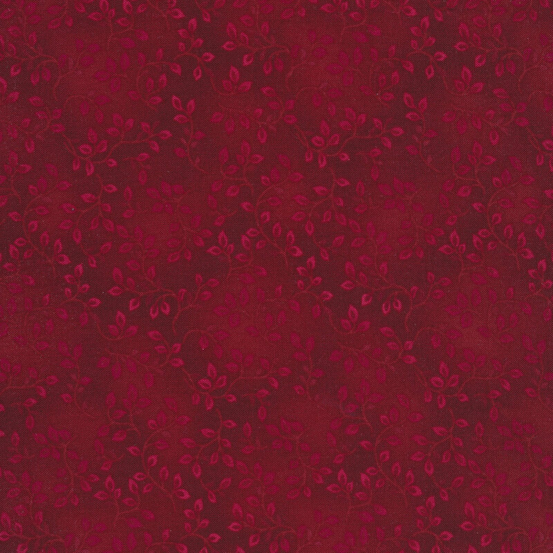 A tonal wine colored fabric with vines and mottling