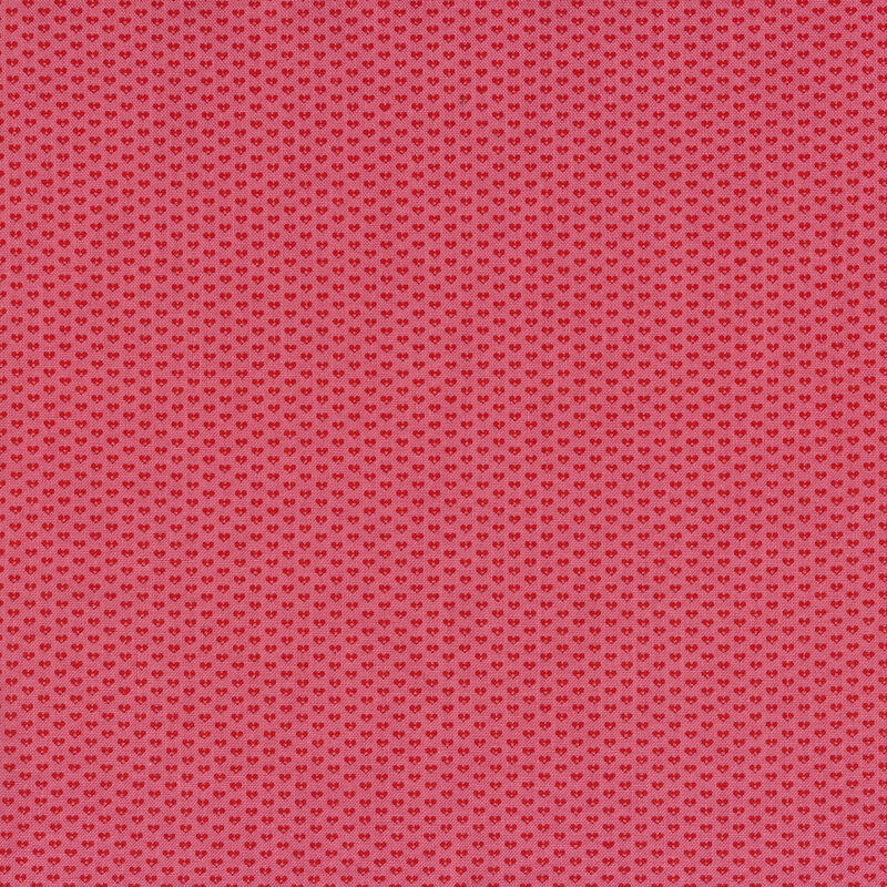 Pink fabric with small red hearts all over