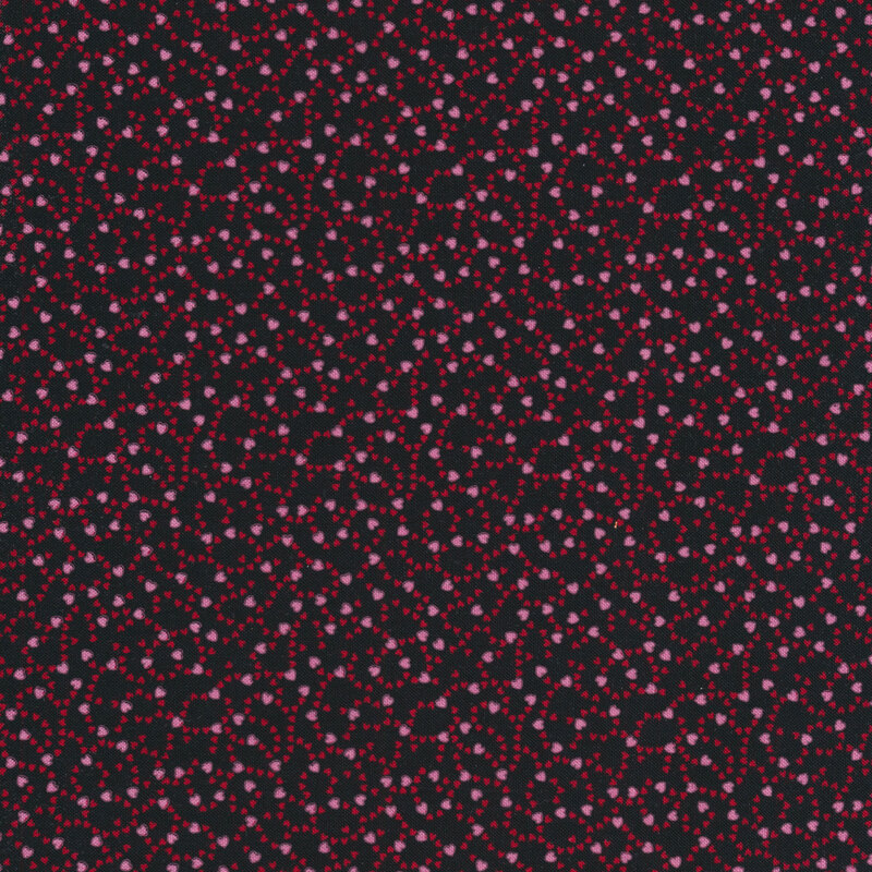 Black fabric with small red hearts and pink heart tracks all over