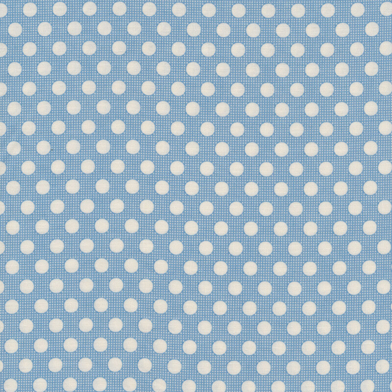 Medium blue fabric with white polka dots all over