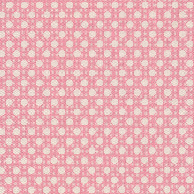 Pink fabric with white polka dots all over