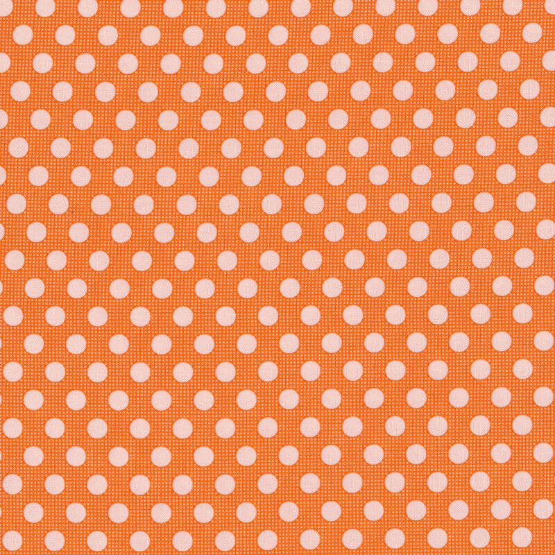 Bright orange fabric with light pink polka dots all over