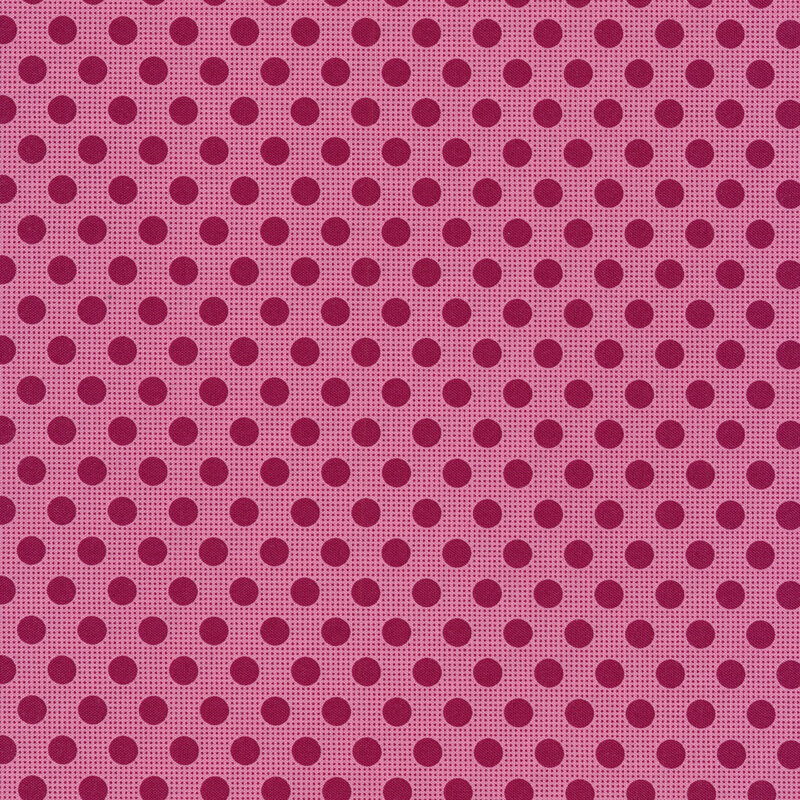 Pink fabric with dark maroon polka dots all over