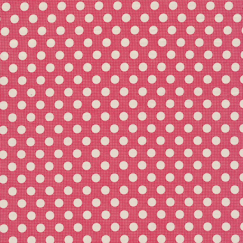 Red sewing fabric with white polka dots all over