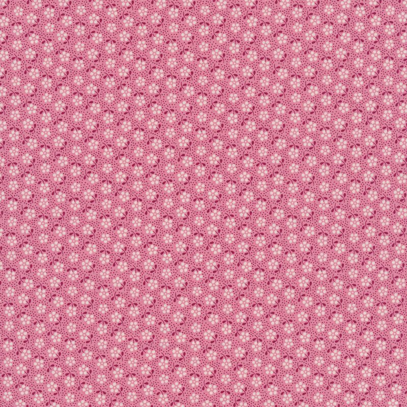 Bright pink fabric with small dark pink dots and tossed white flowers