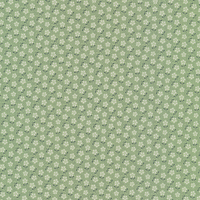 Pale green fabric with tossed white ditsy flowers and small dark green dots