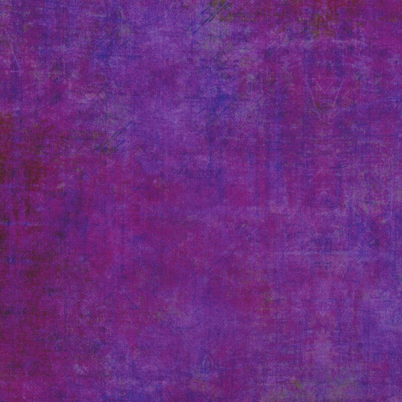 A grunge textured purple fabric with mottling
