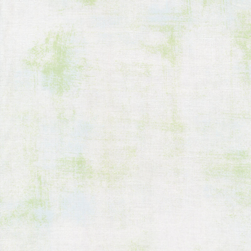 White fabric with bits of green grunge texturing