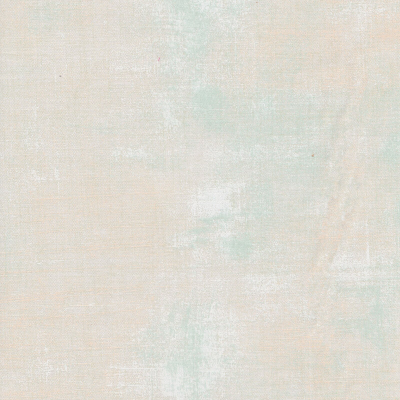 Light cream fabric with bits of pale green grunge texturing