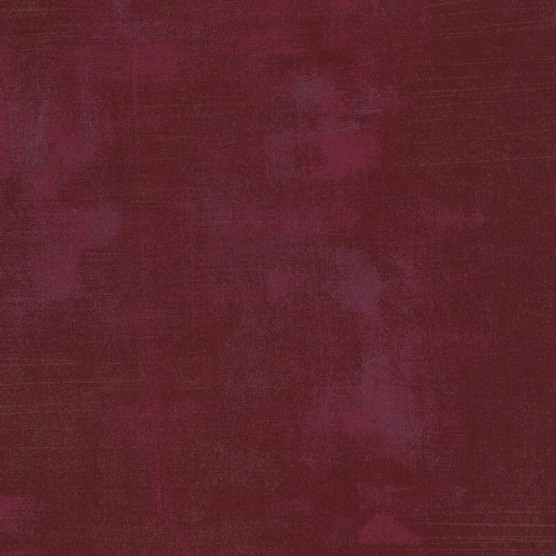Burgundy red fabric with bits of grunge texturing