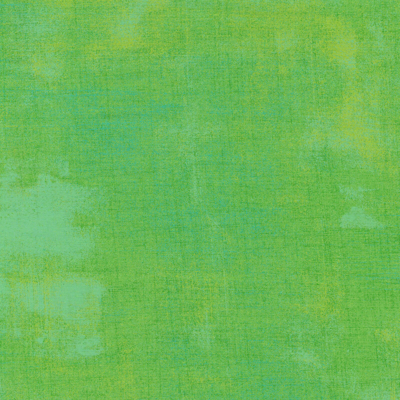 Kiwi green fabric with bits of light teal grunge texturing