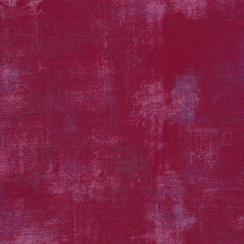 Plum colored fabric with bits of light pink grunge texturing