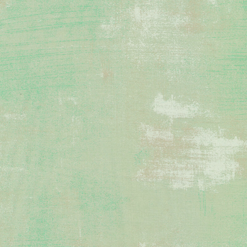 Light mint green fabric with bits of light grey grunge texturing